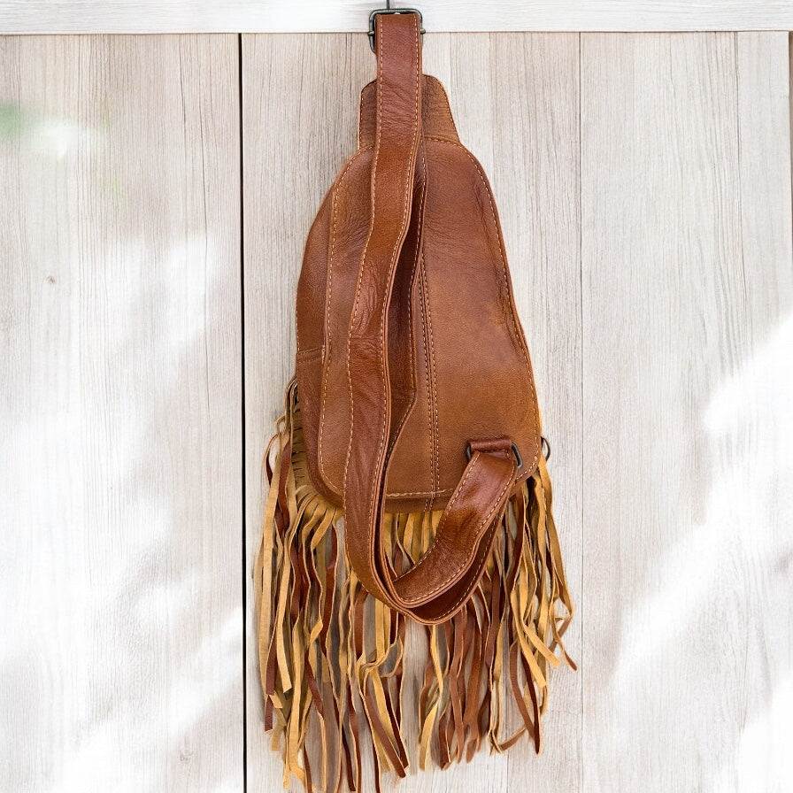 Tan tooled leather fringe sling bag